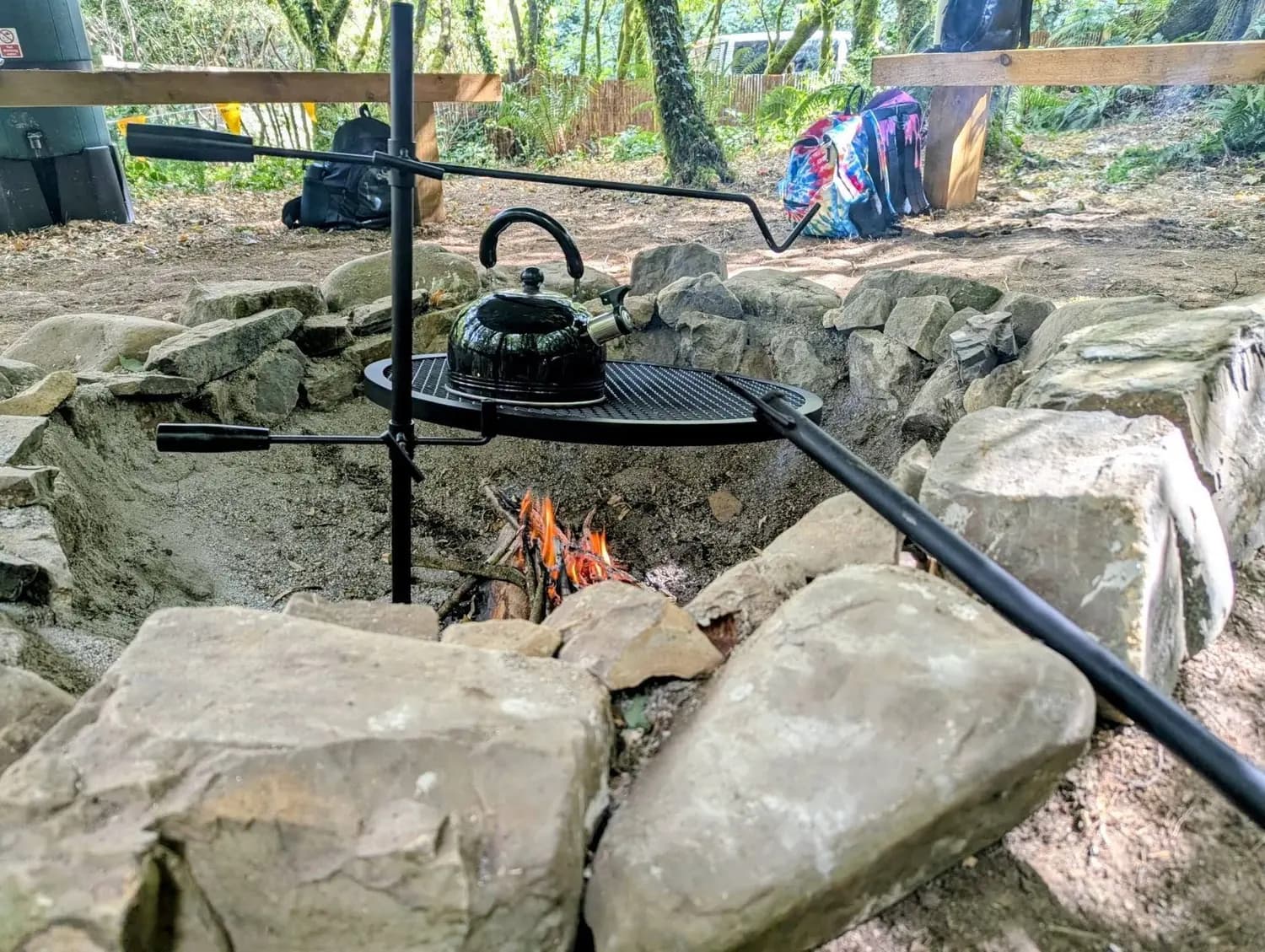 A kettle on a grill over the stone-built campfire circle